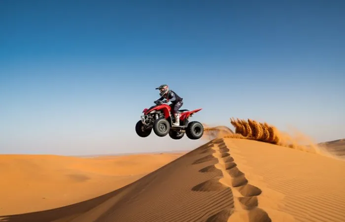 Camel ride and sandboarding on Dubai desert dunes