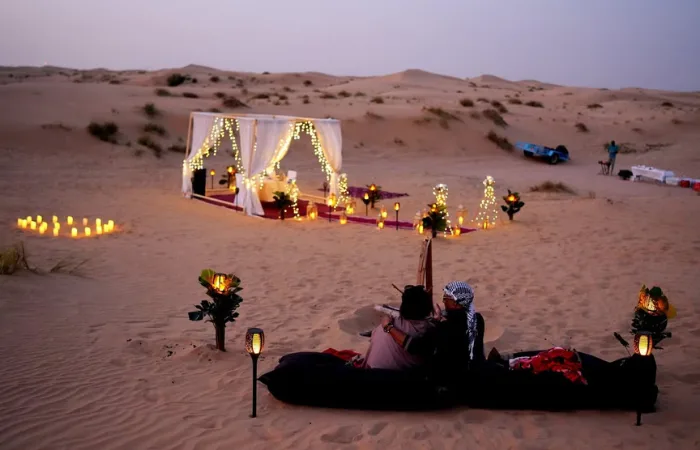 Private Desert Safari Dubai – romantic candlelight dinner setup under Arabian stars